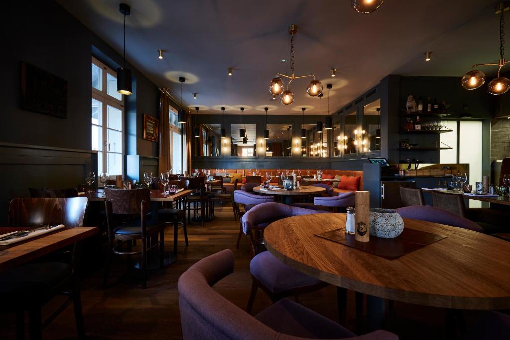 a restaurant with tables and chairs and a bar at Boutique Hotel Spedition a member of DESIGN HOTELS in Thun