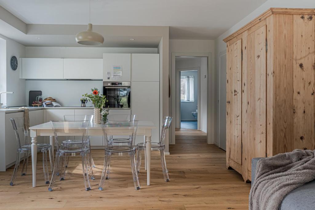 a kitchen and dining room with a table and chairs at iFlat Pinzolo Apartment Gufo in Pinzolo