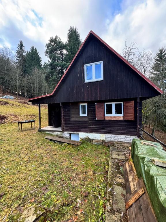 a small house with a gambrel roof at Chata Naděje in Kořenov
