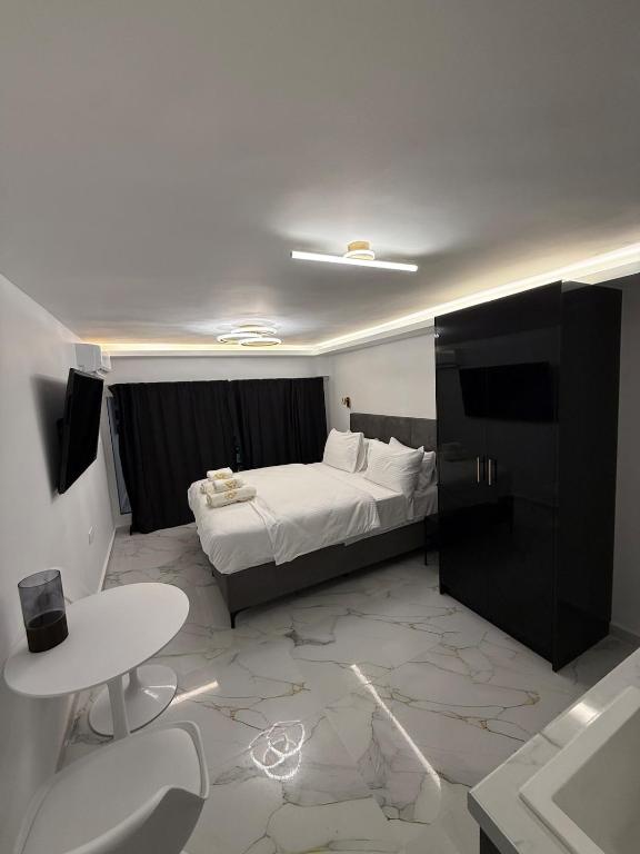 a bedroom with a bed and a desk and a table at City Center Lux Studio in Athens