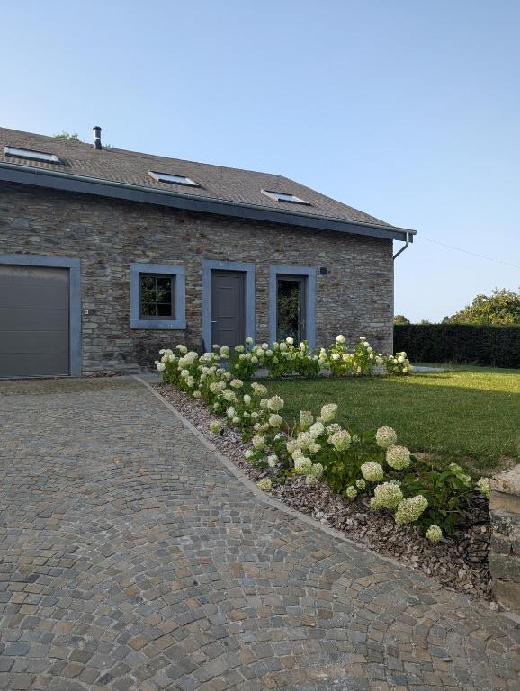 a brick house with a brick driveway at La Petite Reine in Bertrix