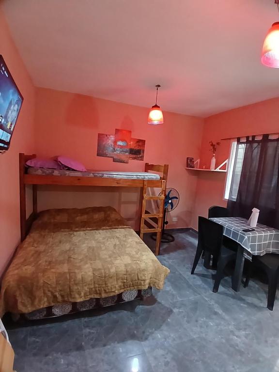 a bedroom with a bed and a desk at Monoambiente San Bernardo in San Bernardo