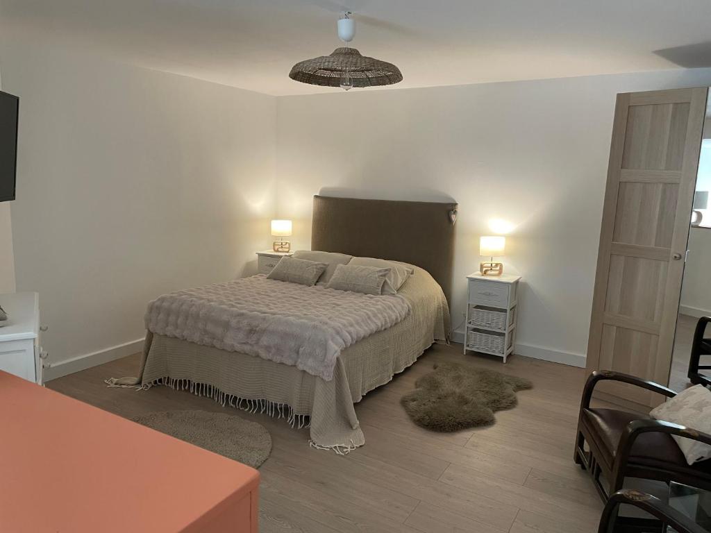 a bedroom with a bed with two pillows on it at À la clef des champs in Chauray