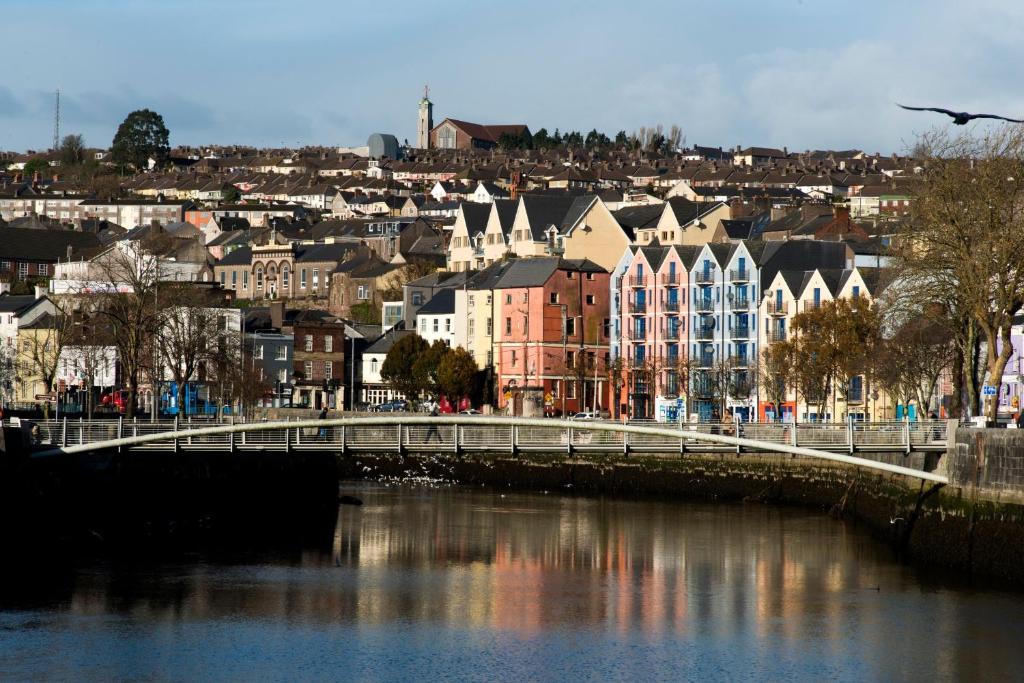 a bridge over a river in a city with buildings at 13 Summerhill South Cork Accommodation in Cork