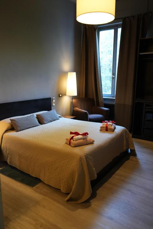 Ένα ή περισσότερα κρεβάτια σε δωμάτιο στο Corridoni Suites