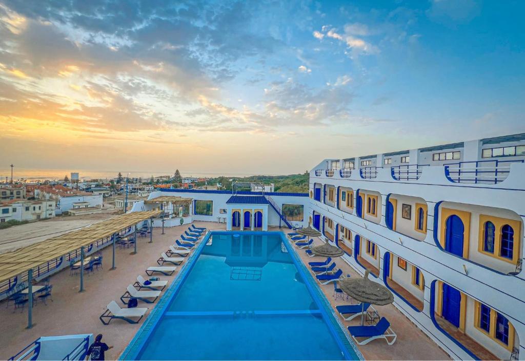 a swimming pool on the roof of a building at arganier solitaire in Souira Guedima