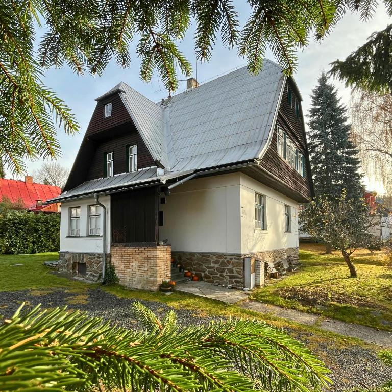 a small house with a gambrel roof at Resident Rebels in Železná Ruda