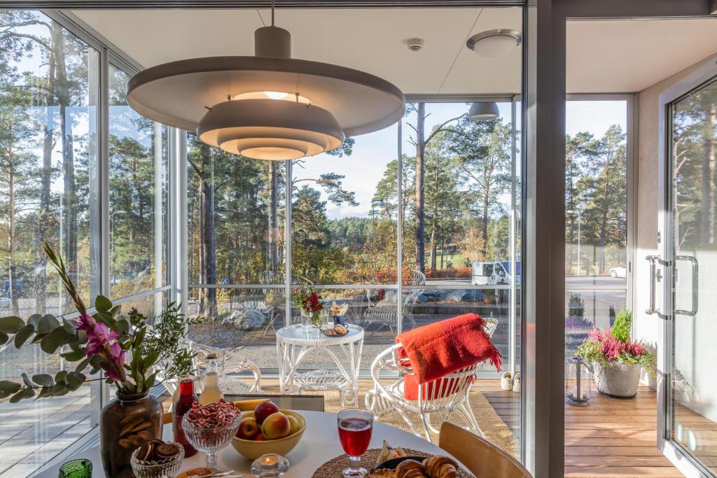 a kitchen with a table and a large window at RUF studio Naantali- Unique design apartment in Naantali