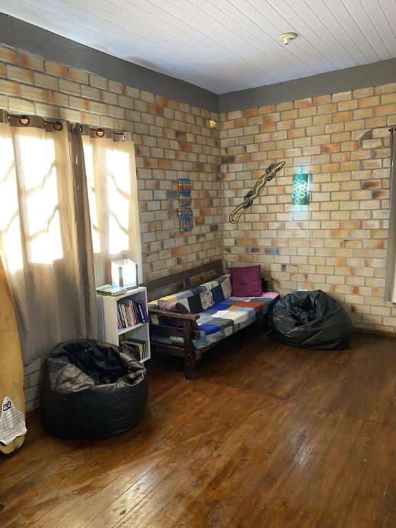 a living room with two bean bags and a couch at Hostel Paraíso Embaú in Guarda do Embaú