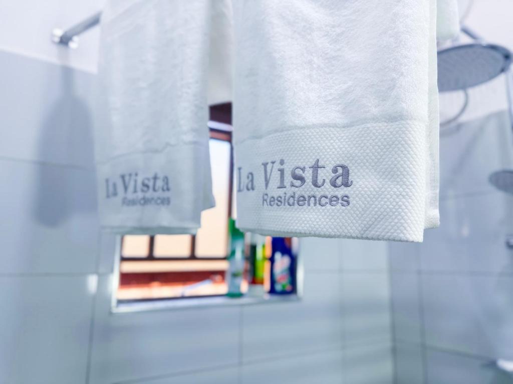 a towel that says vista resistance hanging on a wall at Five-Eight Residences in Jinja
