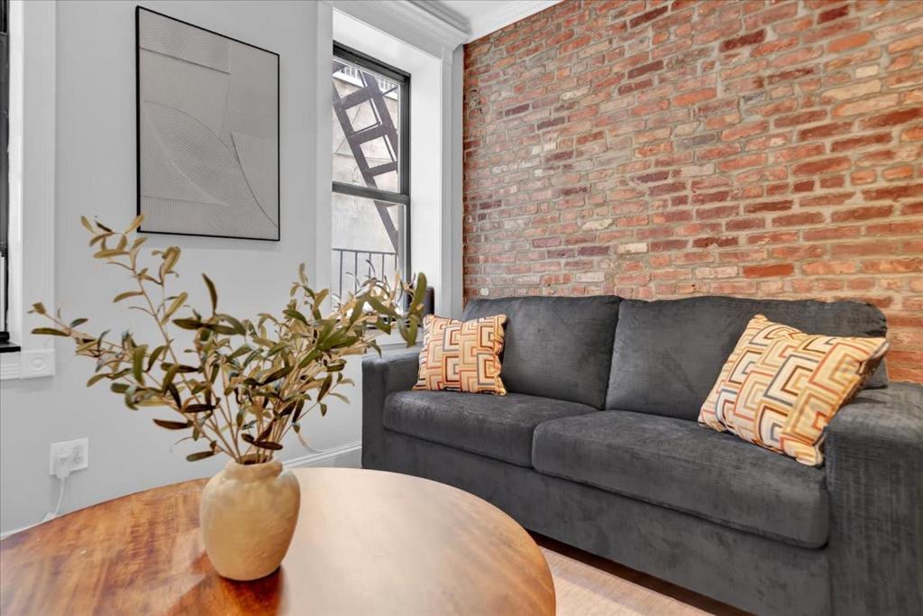 a living room with a couch and a table at Gramercy Apartment - 3BR 2BA Modern Central in New York