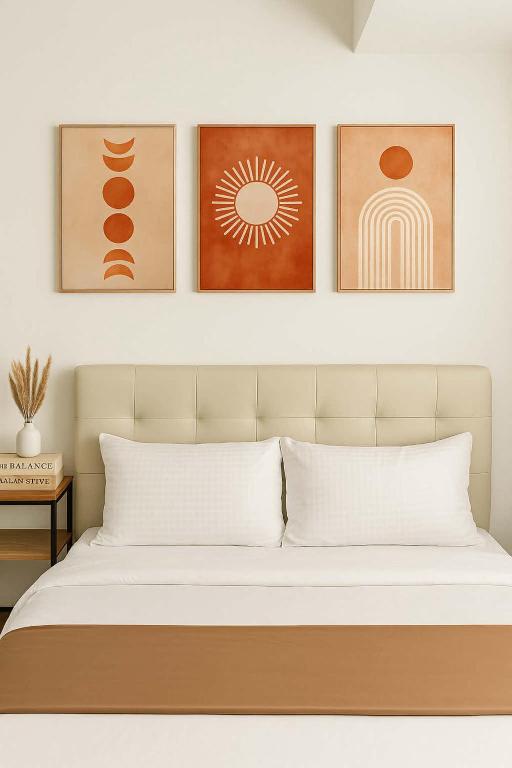 a bedroom with a bed with four pictures on the wall at New Studio Boho Studio with PS4 & Balcony in San Fernando