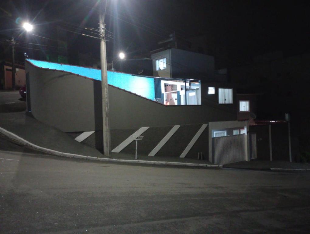 een gebouw op een straat 's nachts met lichten bij Casa piscina in Poços de Caldas