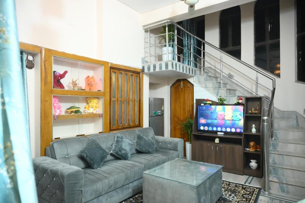 Una televisión o centro de entretenimiento en Archana Home Stay - 10 min from Baidhyanath Temple