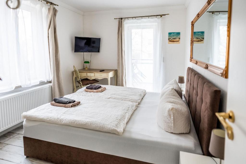 a bedroom with two beds and a mirror at Claras Gartenblick in Schwerin, Nähe Schloss, Hbf & Altstadt, ruhige zentrale Lage, kostenfreie Parkplätze in Schwerin