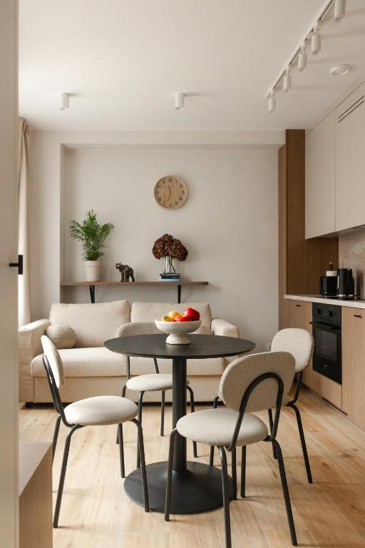 a living room with a table and chairs and a couch at Apartament Perła w Kłodzku 2 in Kłodzko