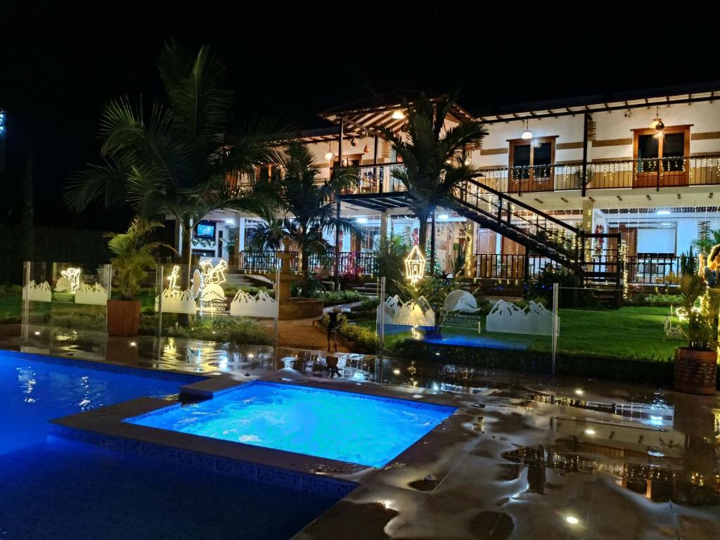 Hotel Pliosaurio Campestre في فيلا دي ليفا: منتجع به حمام سباحة في الليل