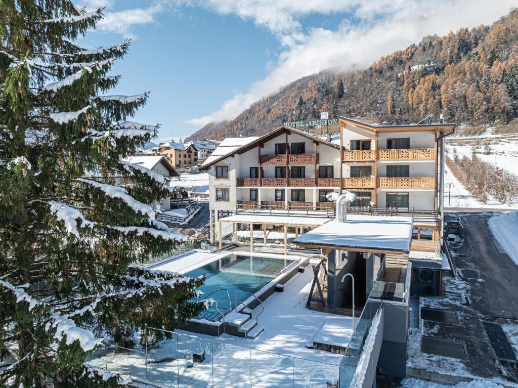 a resort with a swimming pool in the snow at Hotel Ariston Garden & Spa in Monclassico