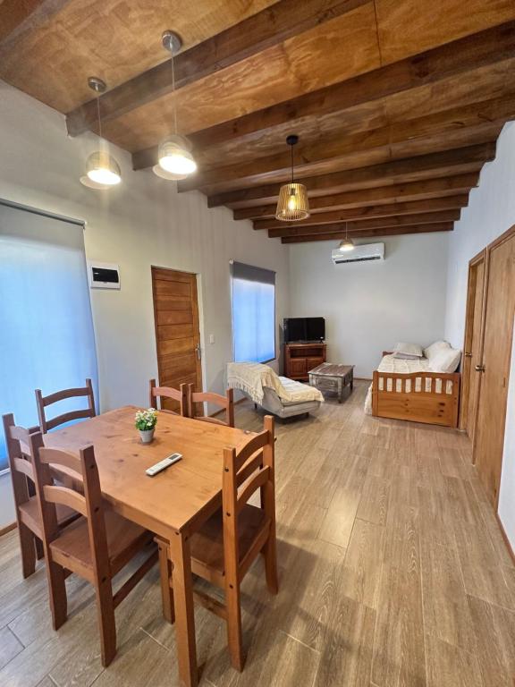 a living room with a wooden table and a bedroom at Carpe Diem in Ocean Park