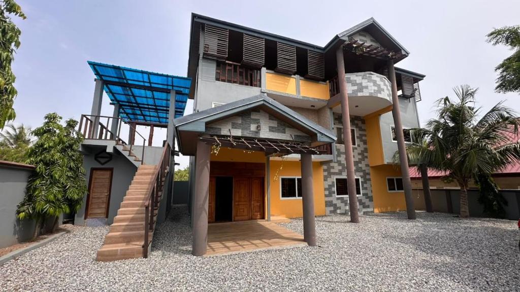 a house with a blue chair on top of it at Private Home with Access to Beach Front -Krokrobite in Kokrobite