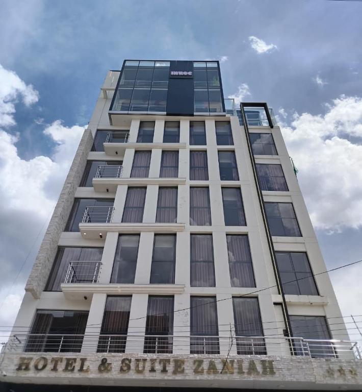 a tall white building with a sign on it at Hotel Zaniah in Huancayo