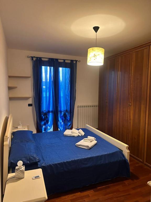 a bedroom with a blue bed with towels on it at La Riviera in Mira