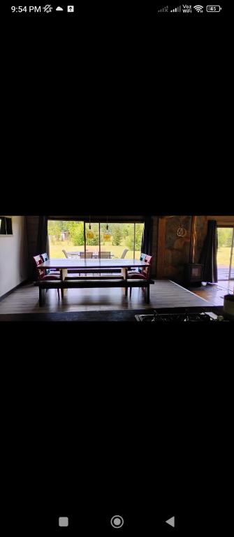 two benches sitting in front of a building at Casa Palguin in Minetué