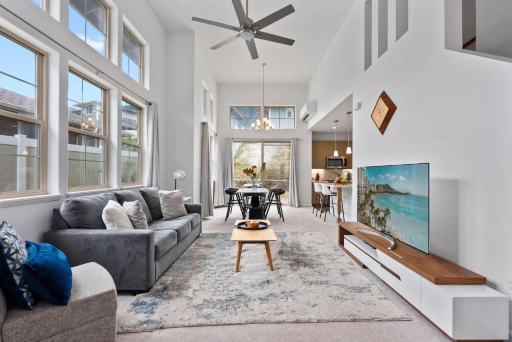 a living room with a couch and a table at Marbella Lane - Elegant 3BR w Marvelous Views in Waianae