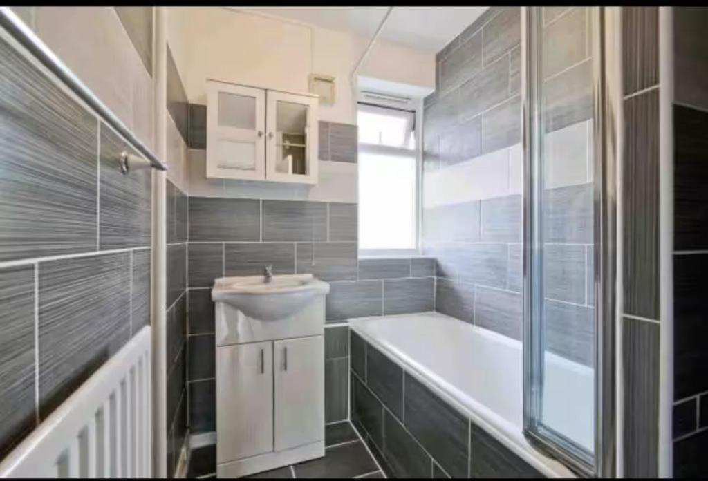 un bagno con vasca e lavandino di Barker House a Londra