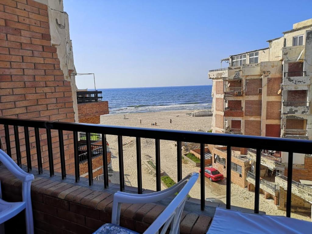 a balcony with two chairs and a beach at Apartment in ALEX - AGMI in Alexandria