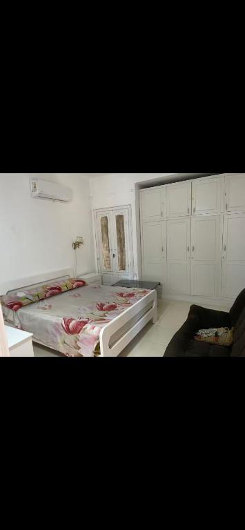 een slaapkamer met een groot bed en een bank bij chalet ramsis village in Alexandrië