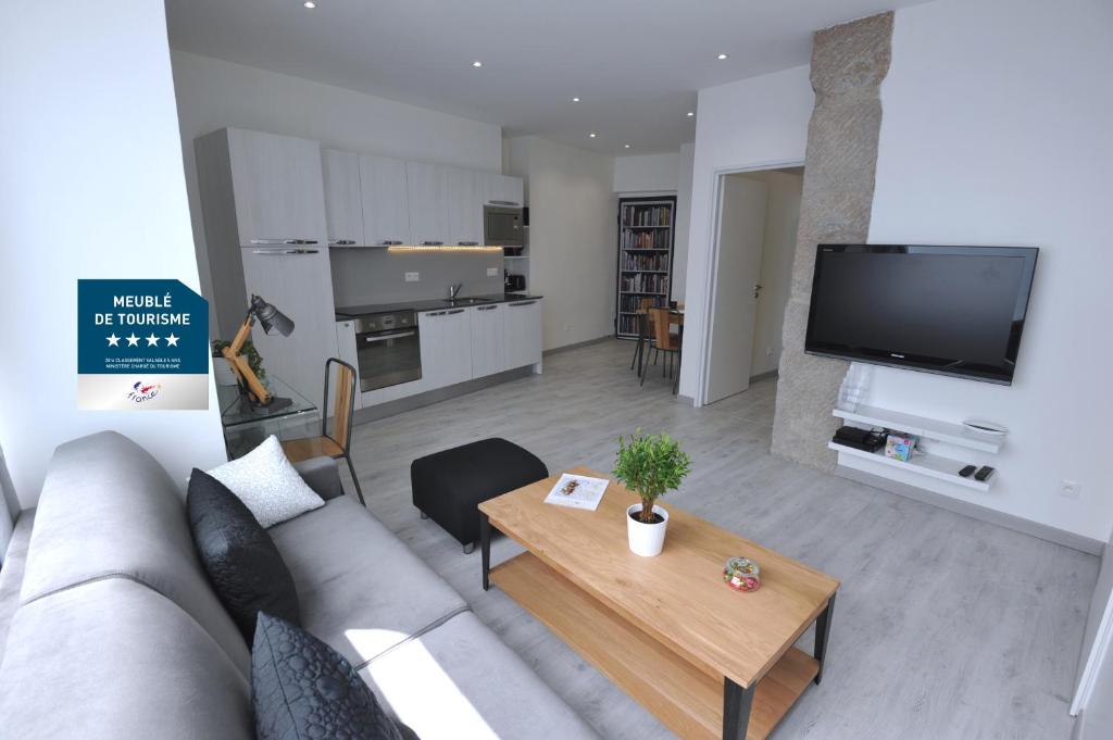 a living room with a couch and a table at Le 10 - Nice Massena in Nice