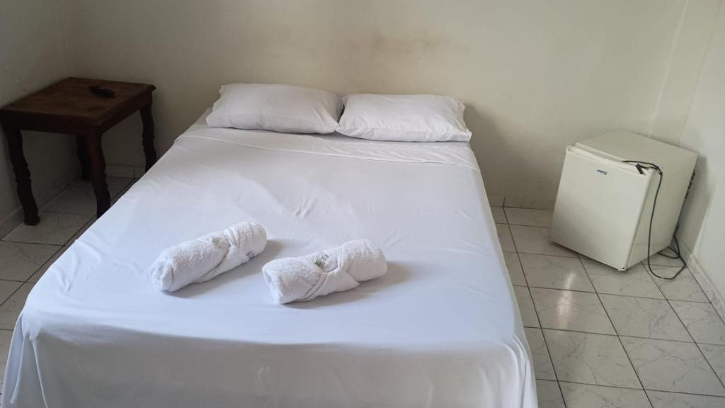 Ένα ή περισσότερα κρεβάτια σε δωμάτιο στο Pousada Rose Alves