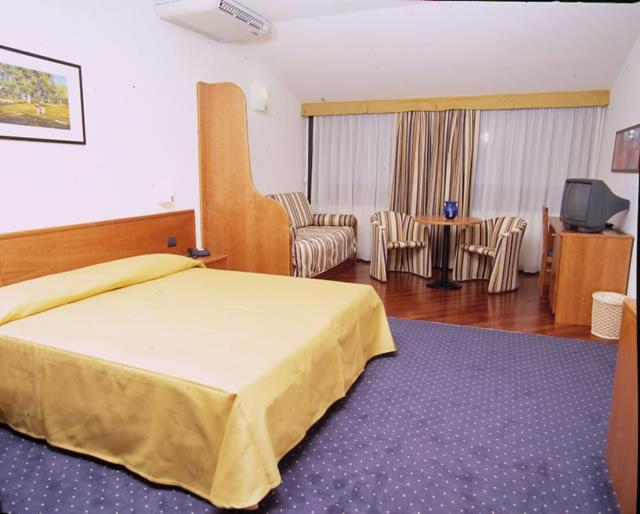 En eller flere senge i et værelse på Hotel Serenella