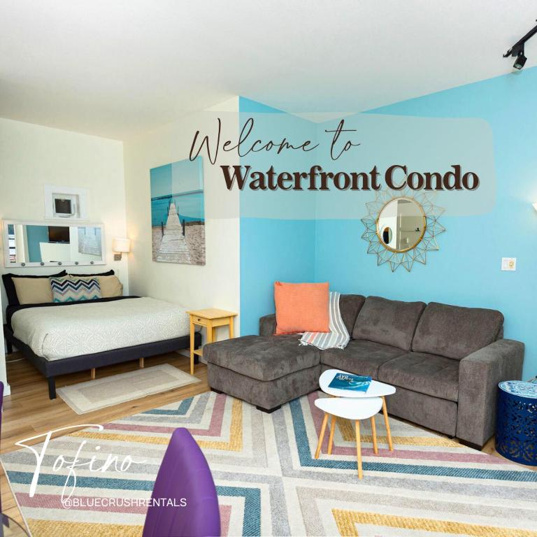 a living room with a couch and a bed at Tofino Waterfront Condo in Tofino