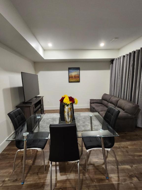 a living room with a table and chairs and a couch at Lakeview Breaktrail Stays in Bedford