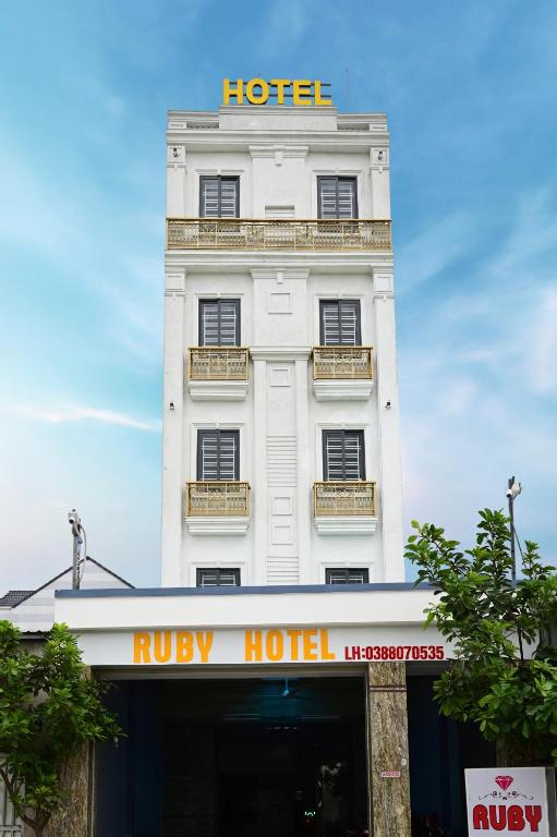 a white building with a hotel sign on it at Ruby Hotel - Bình Cơ - TPHCM - Tân Uyên cũ in Hoi Nghia