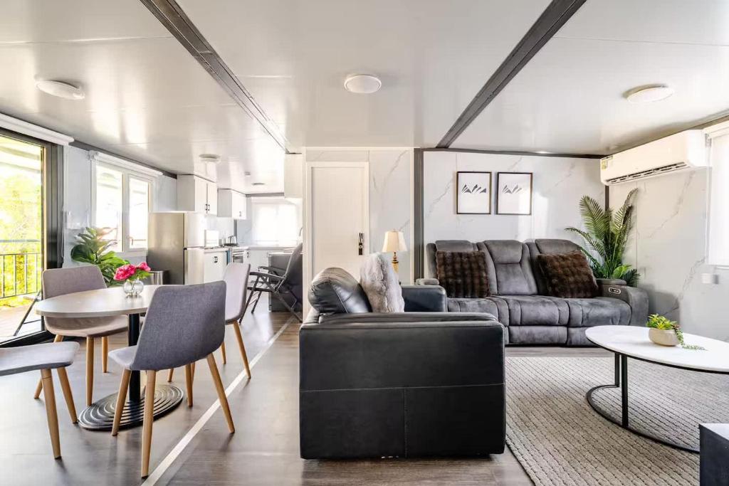 a living room with a couch and a table at Overlooking a Park - A sunny escape in Rooty Hill