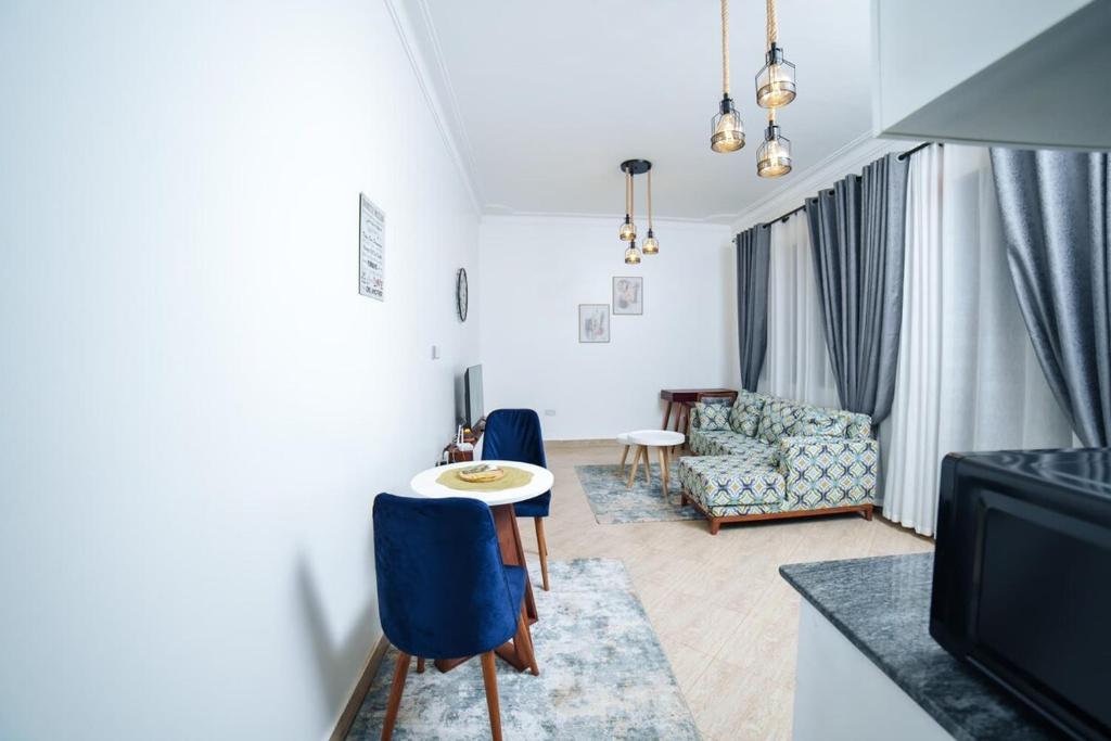 a living room with a table and a couch at Lavista Place in Jinja