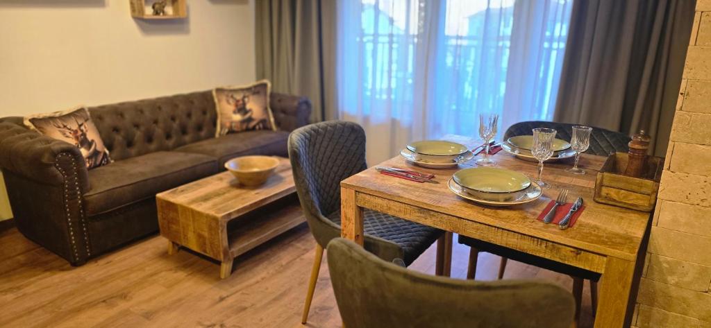 a living room with a table and a couch at Amore Grande in Samokov