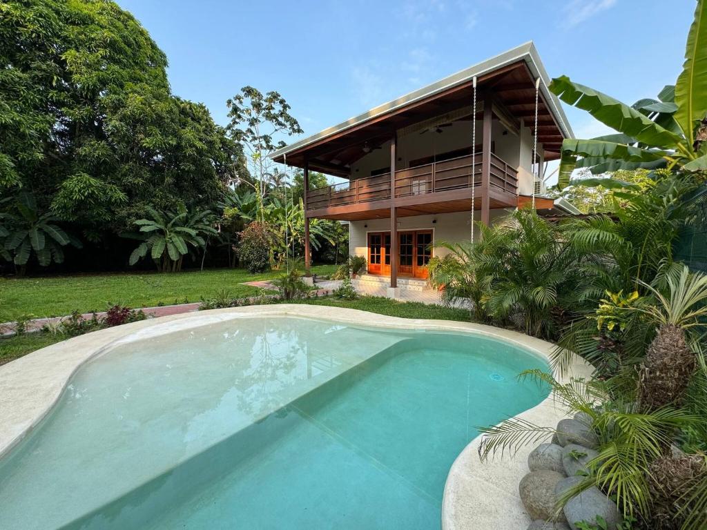 a house with a swimming pool in front of a house at Lillitica in Cocles