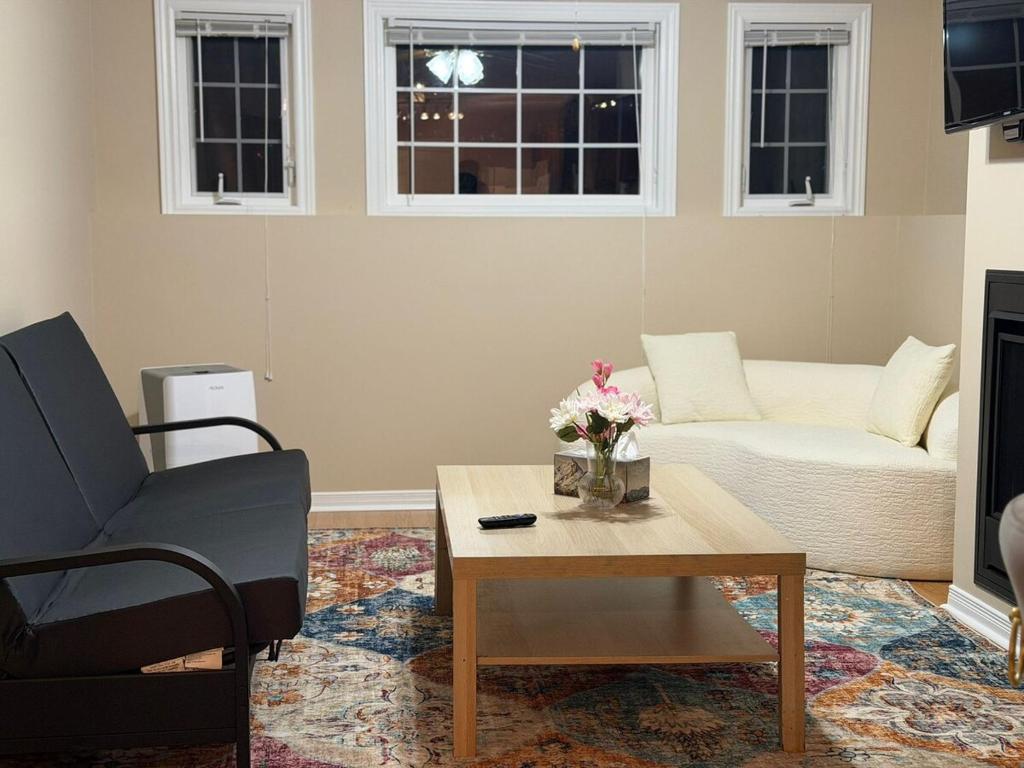 Una sala de estar con un sofá y una mesa de café. en Cozy Private Basement Apartment in Fort Erie, en Fort Erie