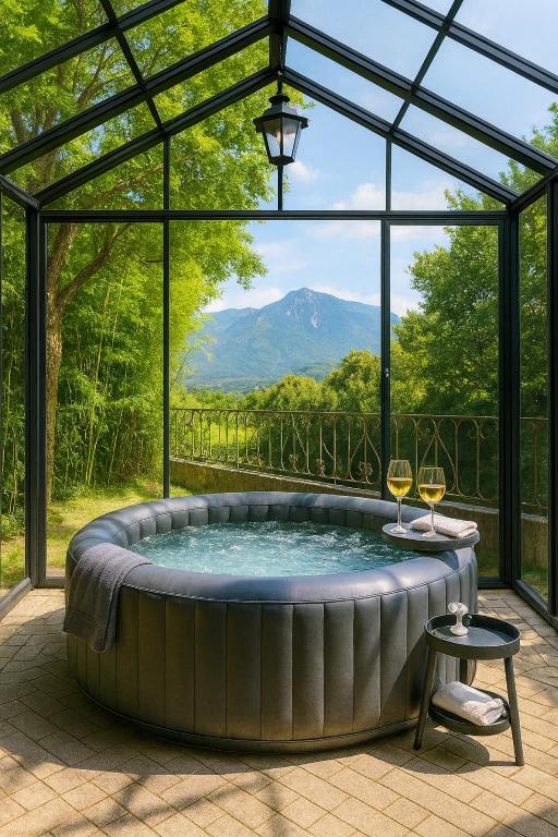 a hot tub in a glass house with a view at Villa De Alexiano in Alixan