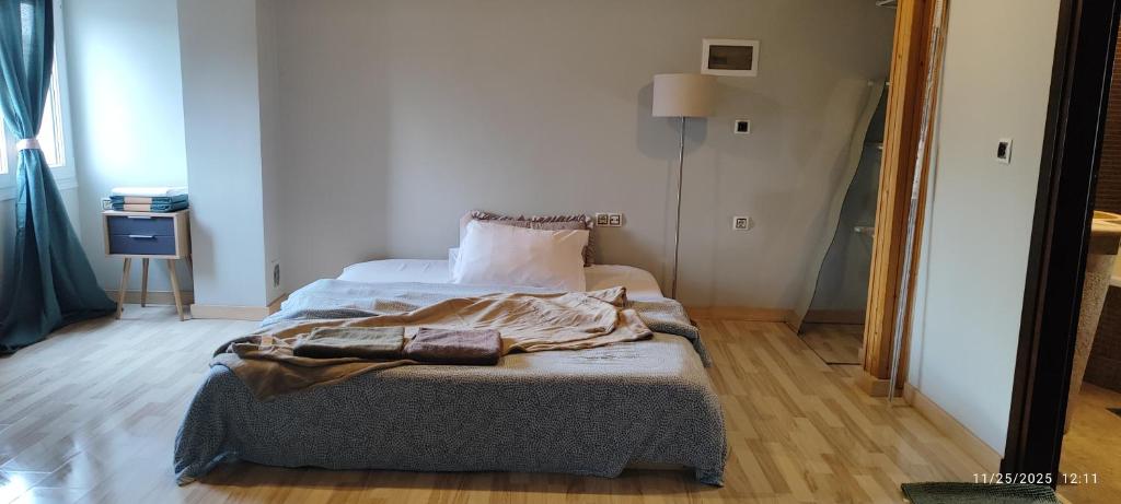 a bedroom with a bed with a blanket on it at JD Maisonette for 4 in Neoi Epivates