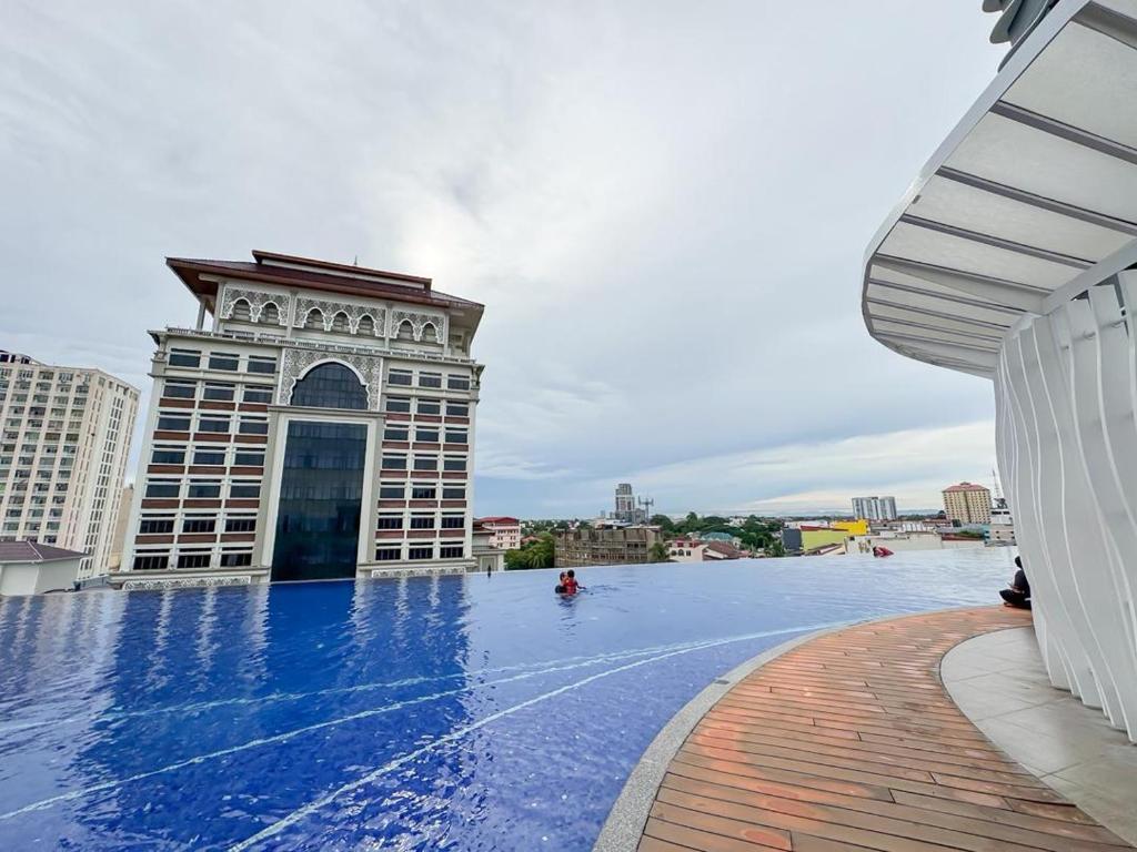 a large swimming pool in front of a building at Troika Residence Kota Bharu by Sakama Homestay in Kota Bharu