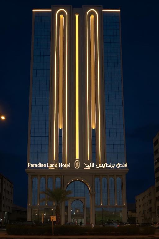 a tall building with a sign that reads paradise level hotel at فندق برادايس لاند الشهداء Paradise Land Hotel Al-Shohada in Al ‘Utaybīyah