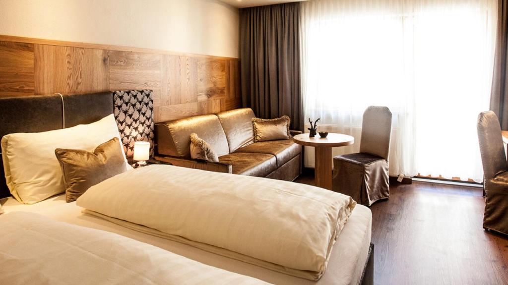 Postel nebo postele na pokoji v ubytování Hotel Gramaser