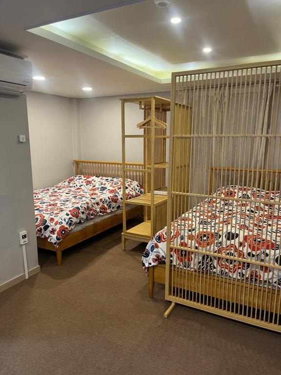 a bedroom with two beds and a bunk bed at Designers Stay Busan in Jung-gu