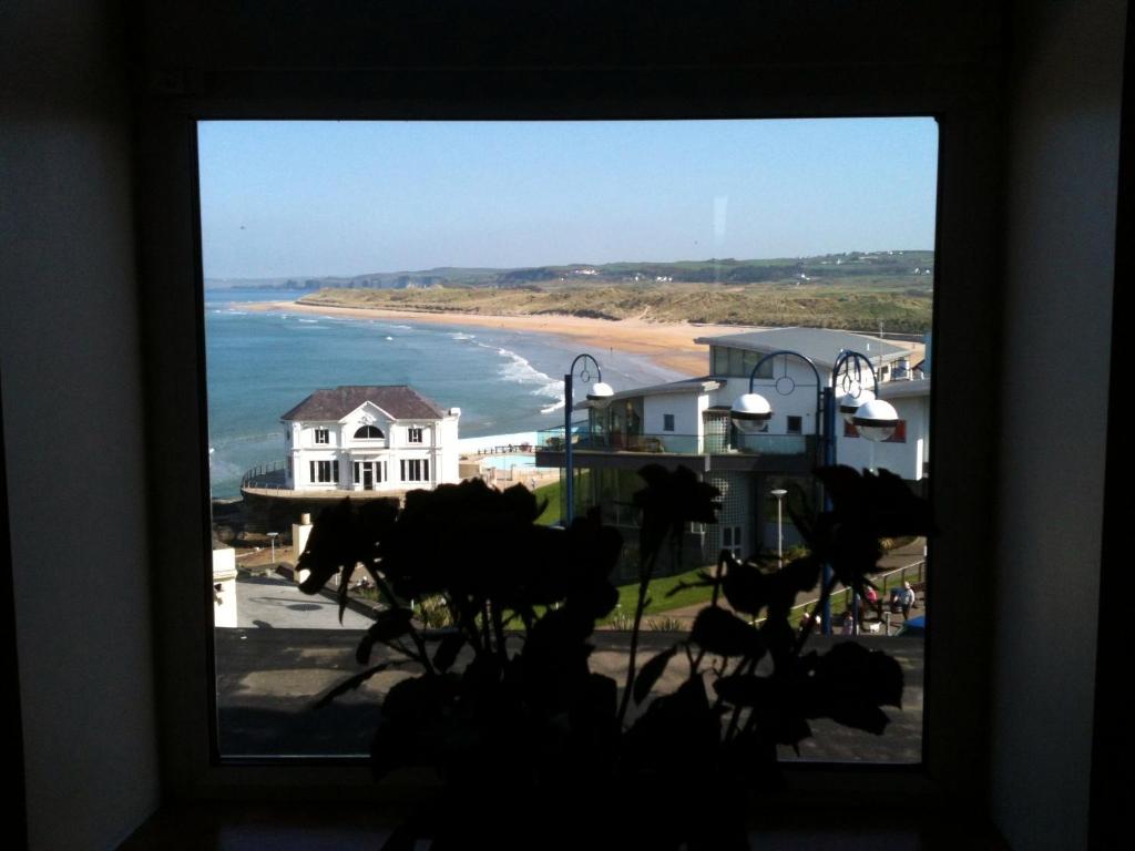 a view of the beach from a window at Albany Lodge in Portrush