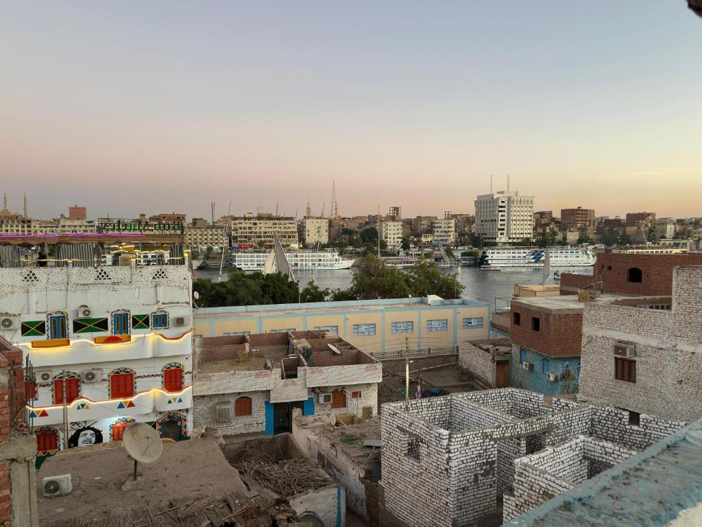 a view of a city with buildings and a river at Nasser Nubian Guest House in Jazīrat Aswān